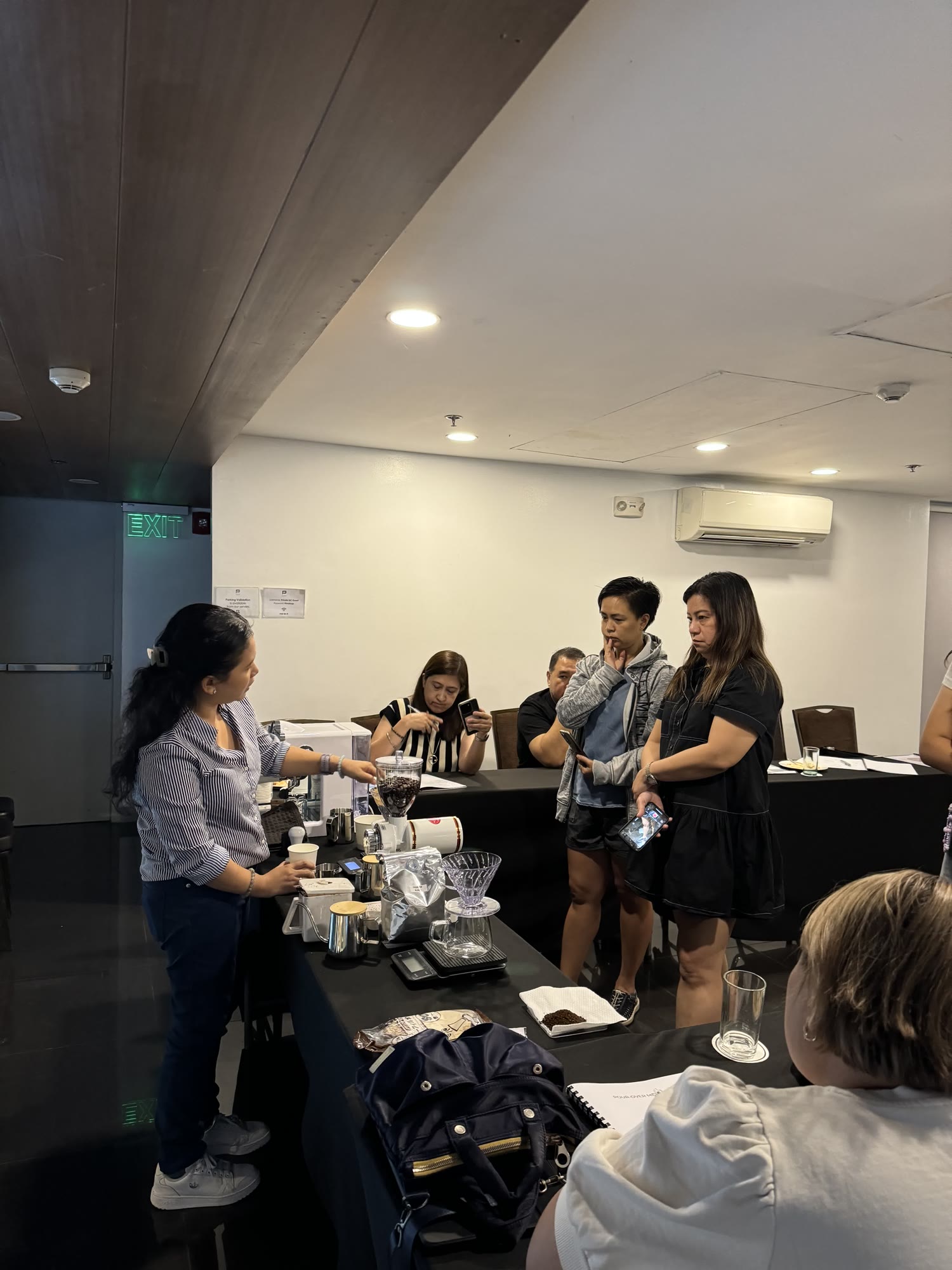 An instructor demonstrating at the brew bar while the class watches
