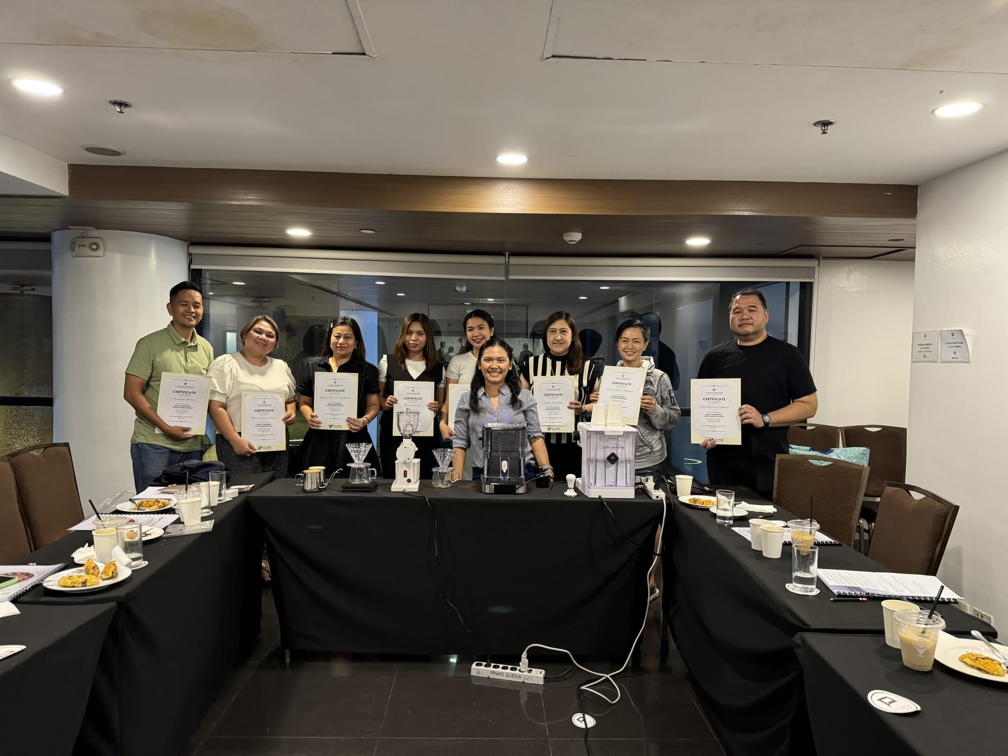 A class holding their certificates of completion