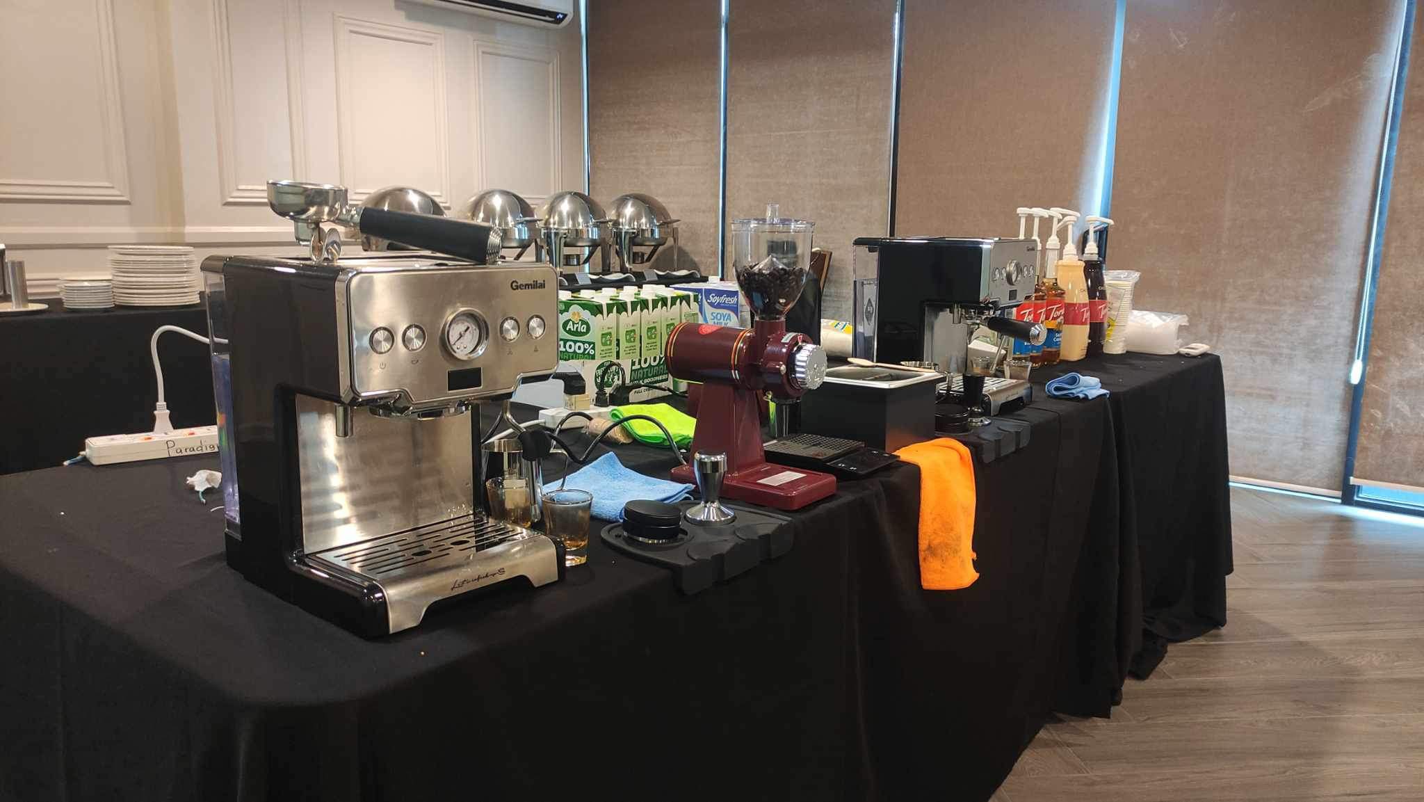 The espresso machine, grinder and bar setup before a session