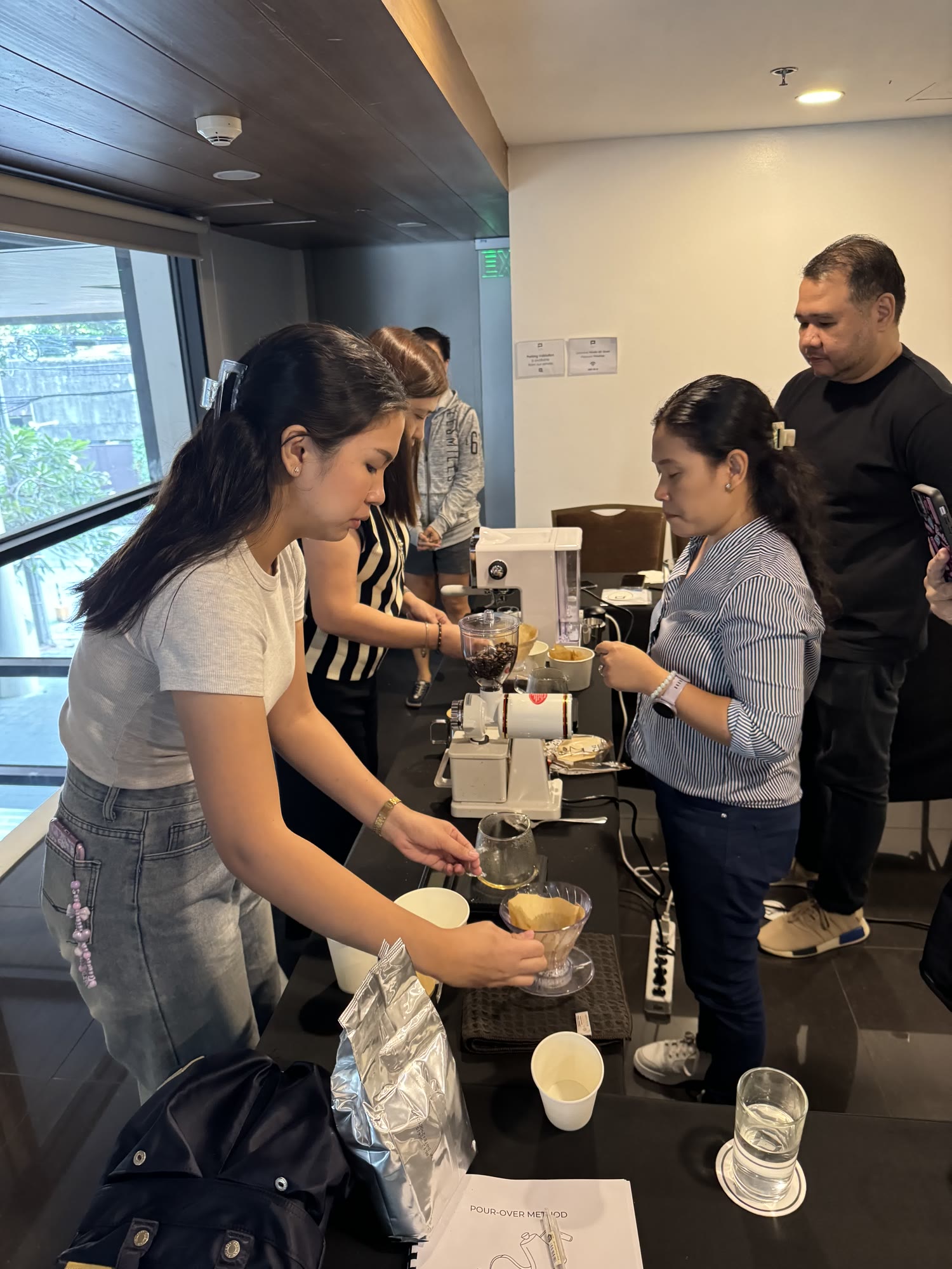 Participants preparing pourover at the training bar